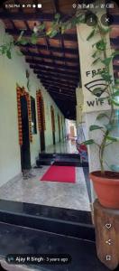 a hallway with a potted plant in a building at Kihim Beach Resort in Kīhīm