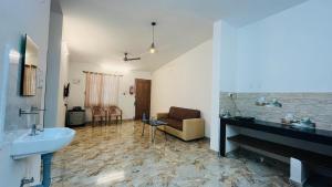 a living room with a sink and a sink at LX premium cottages - Udupi in Udupi