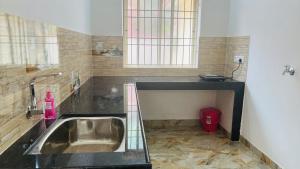 a bathroom with a sink and a window at LX premium cottages - Udupi in Udupi