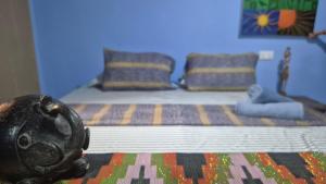 a bedroom with a bed with a statue of a gorilla on it at Emo Guesthouse in Kpandu