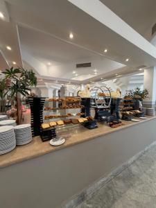 a bakery with a counter with plates and cakes at MDS Coral Bay Pearl Sea View Resort in Sharm El Sheikh