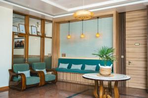a waiting room with a blue couch and two chairs and a table at Season Paradise in Thulusdhoo +136 photos