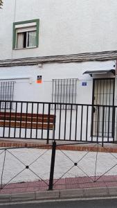 a building with a bench next to a fence at Los Naranjos de Marbella in Marbella