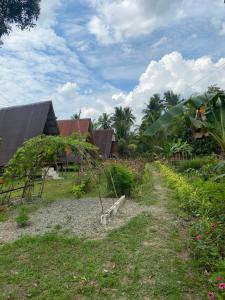 a garden with a tree in the middle of a field at Kubo Ni Cesar in Batuan