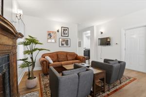a living room with a leather couch and chairs at Walk to VA DMC 2BR 2 FULL Baths Midtown in Detroit