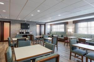a waiting room with tables and chairs at Hampton Inn La Junta in La Junta