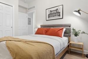 a bedroom with a bed with orange pillows at Walk to VA DMC 2BR 2 FULL Baths Midtown in Detroit