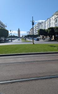 an empty street in a city with buildings and grass at appartement Rabat Gare à 3min,Rabat honey house in Rabat