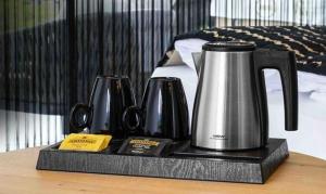 a tea kettle on a tray on a table at Lake Side Mantra in Khamshet