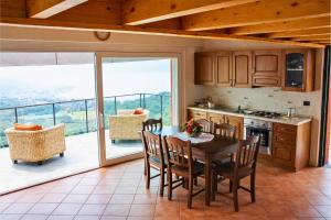 a kitchen with a table and chairs and a balcony at Residenza Roggiolo in Luino