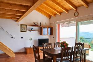 a dining room with a table and a television at Residenza Roggiolo in Luino