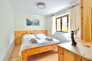 a bedroom with a wooden bed and a window at Hobel`s Home in Wildalpen