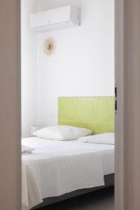 two beds with white sheets and a green headboard at Résidence Canava in Bonifacio +13 photos
