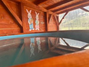 a view of a swimming pool in a wooden cabin at Cabana Paltini in Costeşti