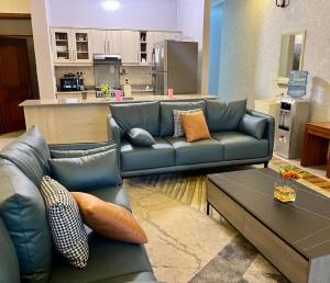 a living room with a couch and a table at KiGALI NORMAL VIEW APARTMENT in Kigali