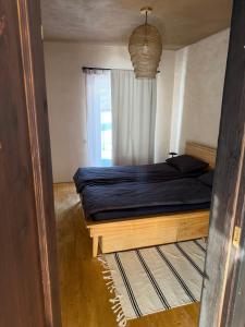 a bedroom with a bed and a window at Clay House in Pāvilosta