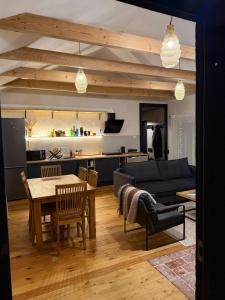 a living room with a table and a couch at Clay House in Pāvilosta