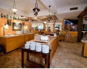 a restaurant with a table with white plates on it at Stelo Appartments in Gosau
