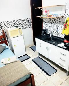 a kitchen with a sink and a counter top at Kitnet Harmonia in Campo Grande