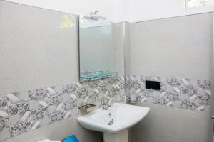 a bathroom with a sink and a mirror at Malika homestay in Midigama East +34 photos