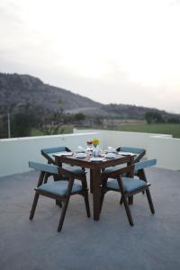 a wooden table and chairs with a meal on it at Soma Jawai in Bijāpur