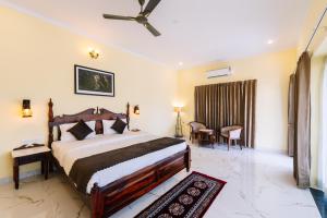 a bedroom with a large bed with a ceiling fan at Soma Jawai in Bijāpur