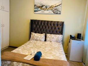 a bedroom with a bed with a bedspread at GLOBALNEST guest house in Cape Town +4 photos