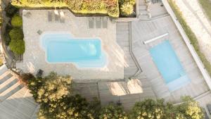an overhead view of two swimming pools in a yard at Résidence Canava in Bonifacio