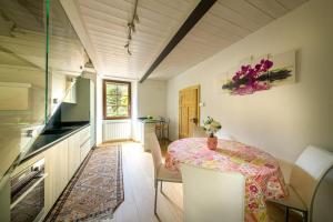 a room with a table and chairs and a window at Casa Vacanza Nonna Pia I & III in "Piazza Basilica" in Tirano