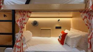 a bedroom with two bunk beds with red and white pillows at Moustache Jaipur,Hostel & Rooftop Bar in Jaipur