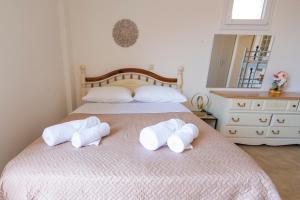 a bedroom with two towels on a bed at Scorpina Horizon Villa in Kalamitsi