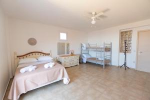 a bedroom with a bed and a dresser at Scorpina Horizon Villa in Kalamitsi +22 photos