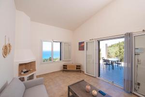 a living room with a couch and a table at Scorpina Horizon Villa in Kalamitsi