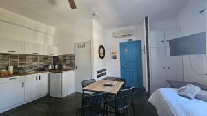 a kitchen and a room with a table and chairs at Enalia Apartments in Korissia