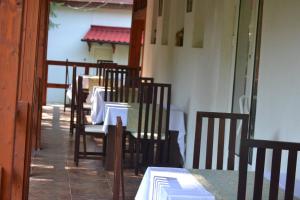a row of tables and chairs in a restaurant at Vila Vanesa in Arieşeni