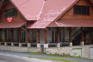 a building with red roofs on the side of it at Vila Vanesa in Arieşeni