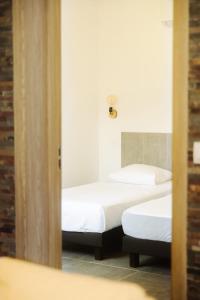 two beds in a room with a mirror at CHALET CANAVA in Bonifacio +13 photos