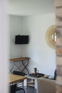 a living room with a tv on a wall at CHALET CANAVA in Bonifacio