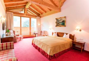 A bed or beds in a room at Rasmushof - Hotel Kitzbühel