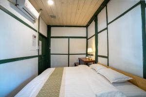 a bedroom with a large white bed in a room at Barn Laos Hostel in Vientiane +71 photos