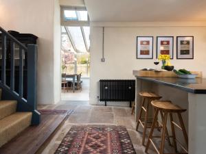 a kitchen with a counter and stools in a room at The Old Coach House in Alnwick