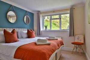a bedroom with a bed with two towels on it at Beer View Cottage in Beer