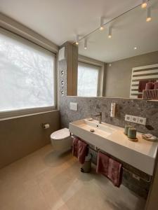 a bathroom with a sink and a toilet and a mirror at Rex Palast in Memmingen