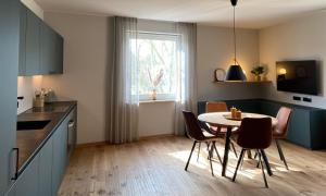 a kitchen with a table and chairs in a room at Rex Palast in Memmingen
