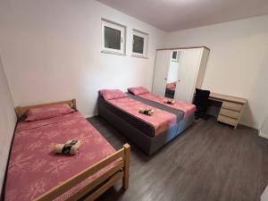 a small room with two beds and a desk at Ela in Žusterna