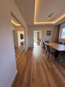 a dining room with a wooden table and chairs at Villa Lungomare-Large Waterfront Apartment -Lungomare Promenade 6 in Cres