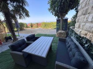 a picnic table and couches in a yard with at Ela in Žusterna