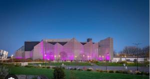 a large building with purple lights in front of it at Le calme dans 100M2 in Condé-sur-Sarthe