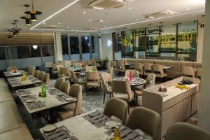 a restaurant with tables and chairs in a room at King's Kraft Shubh Hotel in Dwarka