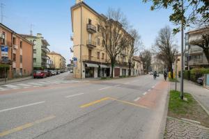 an empty street with a building and a person riding a motorcycle at Venezia, 15 minutes from Venice, Parking,Shuttle airport, Train station Miranese in Mestre